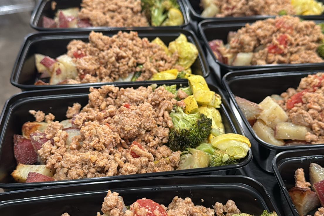 Rows of meal prep containers ready for corporate delivery